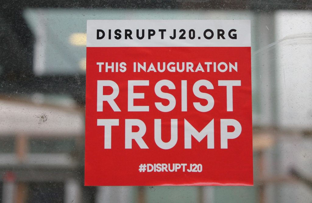 sticker at construction site in DC says "resist Trump" with Disrupt J20 website
